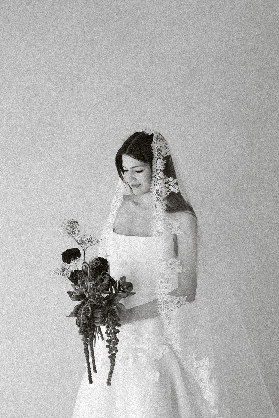 Bride wearing Céleste cathedral mantilla veil with French Leavers lace