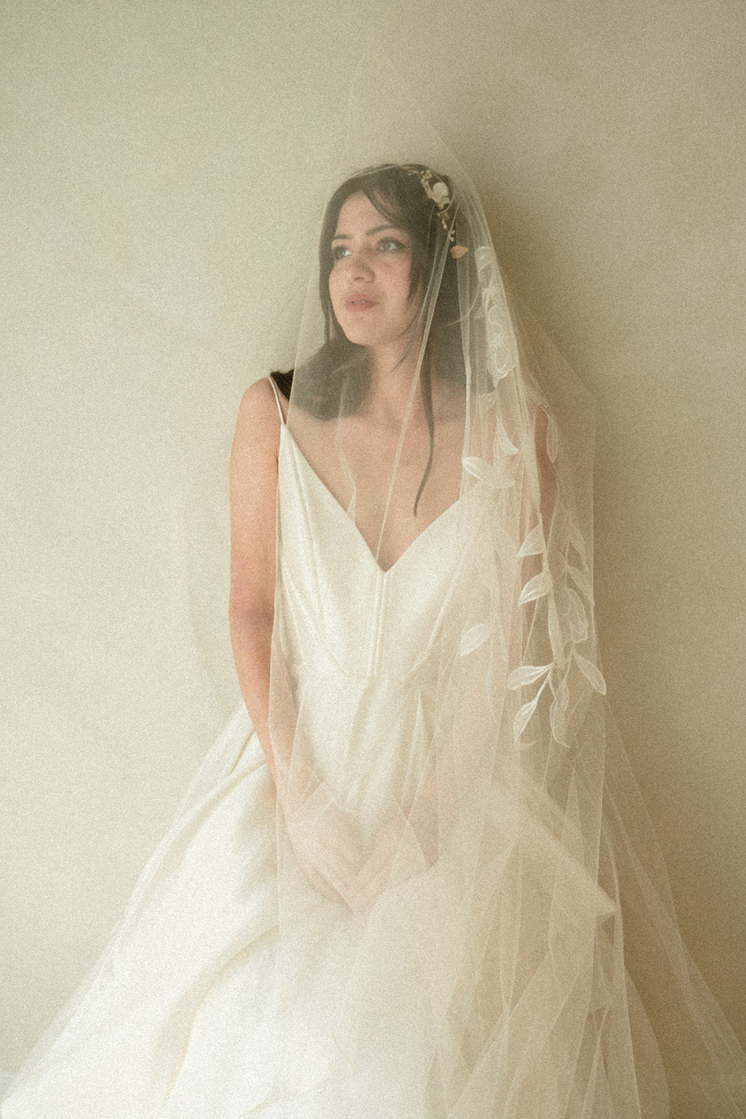 Handcrafted cathedral veil in warm ivory with floral embroidery from crown to fingertip, paired with ivory wedding dress bride portrai