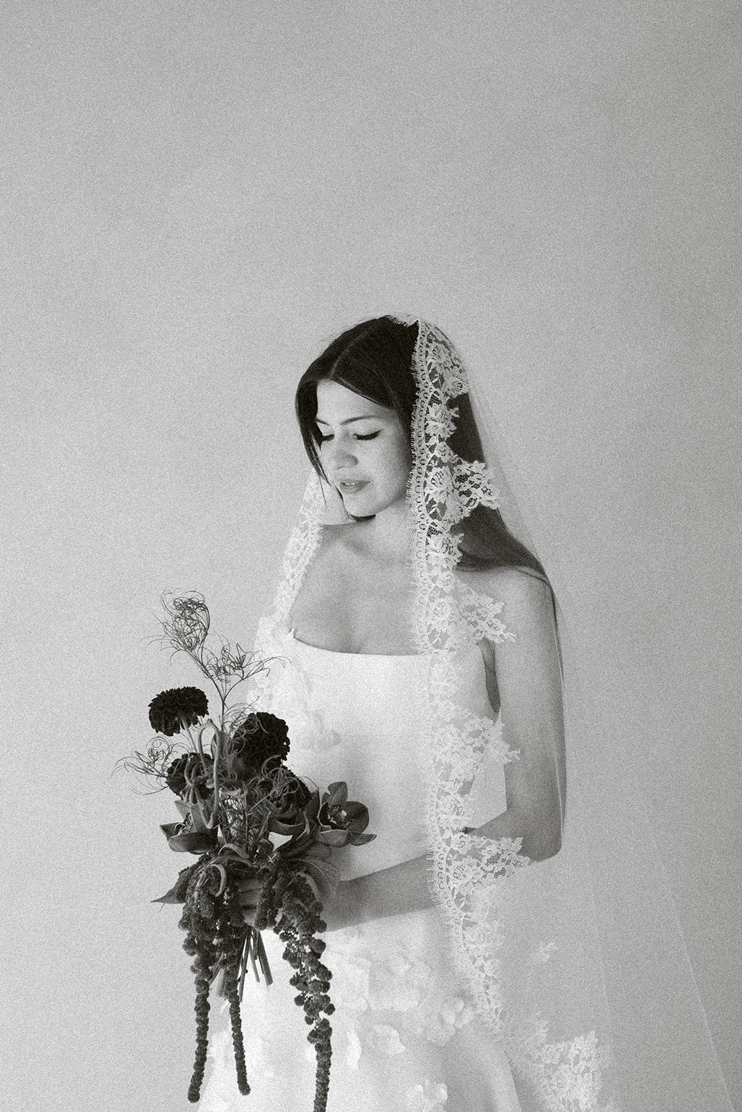 Bride wearing Céleste cathedral mantilla veil with French Leavers lace