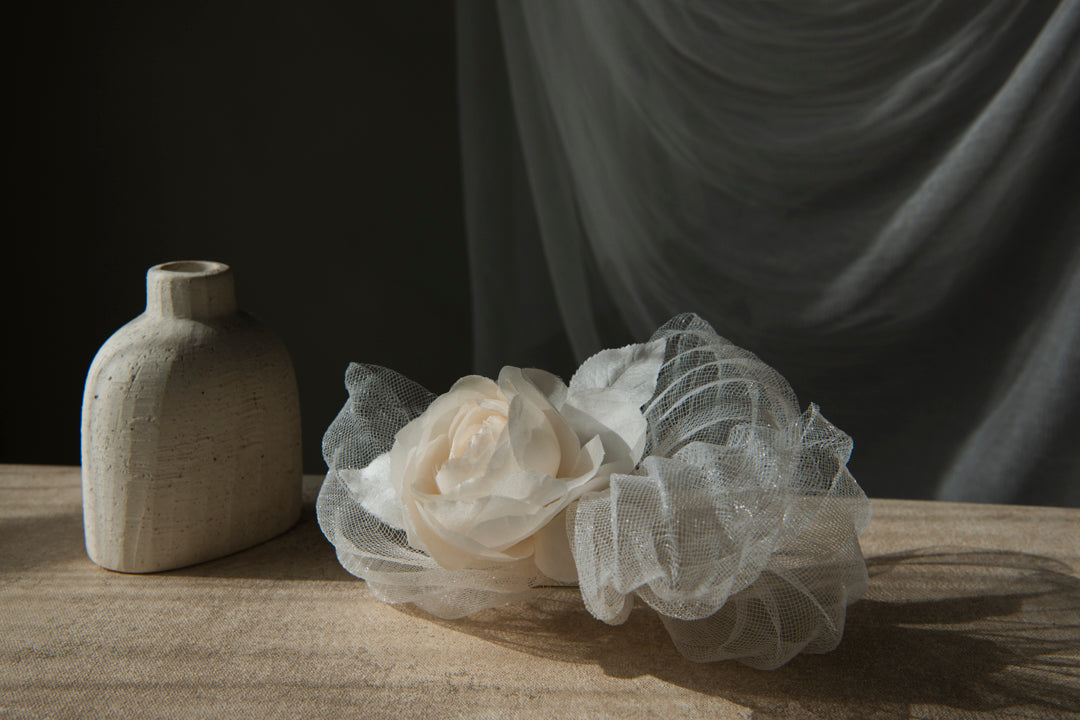 Renoncule ranunculus brooch editorial styling with ceramic vase and silk tulle backdrop