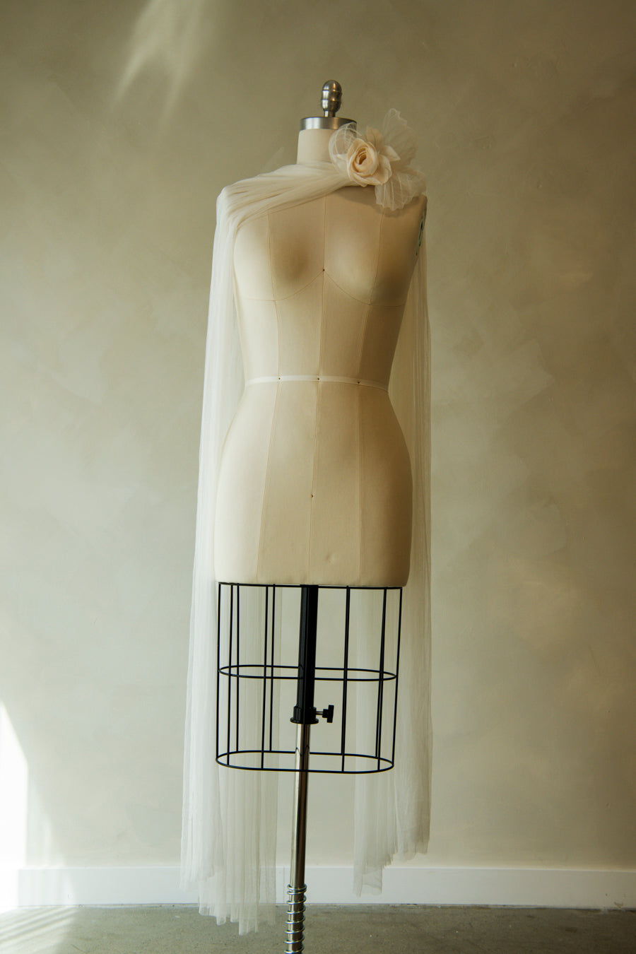 Full length view of Renoncule brooch and fingertip length silk tulle neck scarf on mannequin