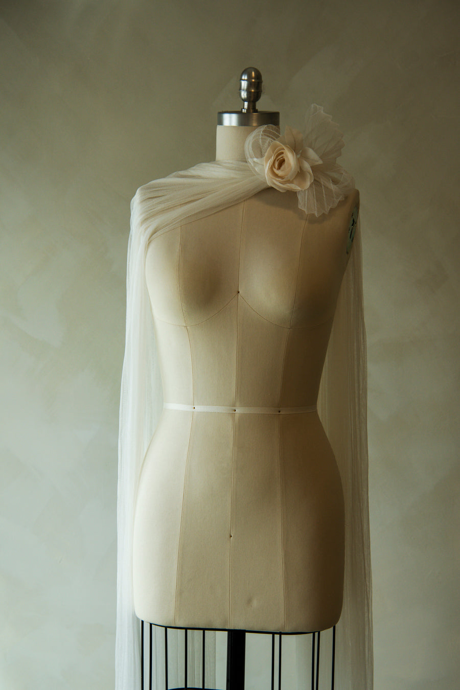 Renoncule brooch paired with French silk tulle fingertip neckscarf on mannequin