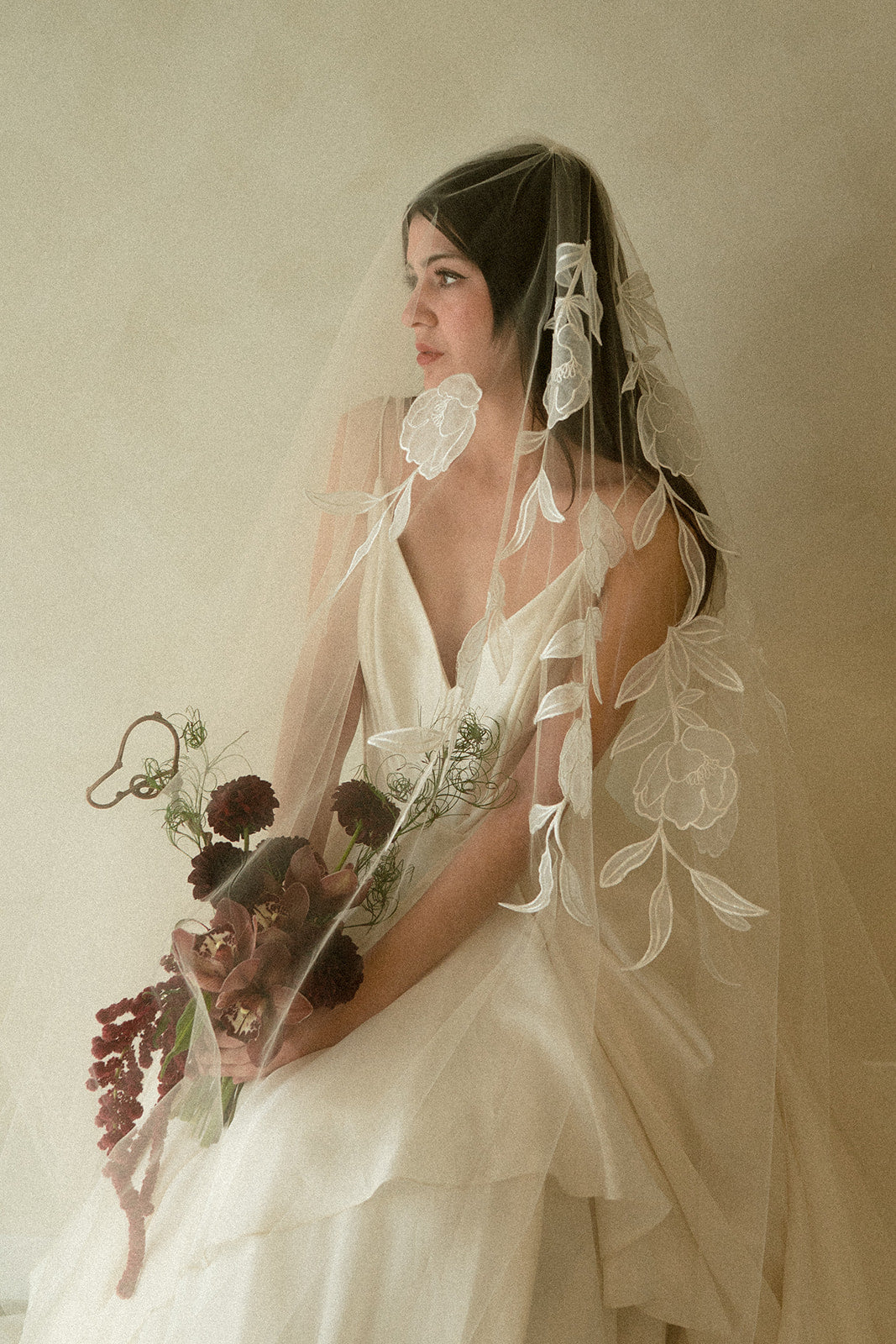 Handcrafted cathedral veil in warm ivory with floral embroidery from crown to fingertip, paired with ivory wedding dress