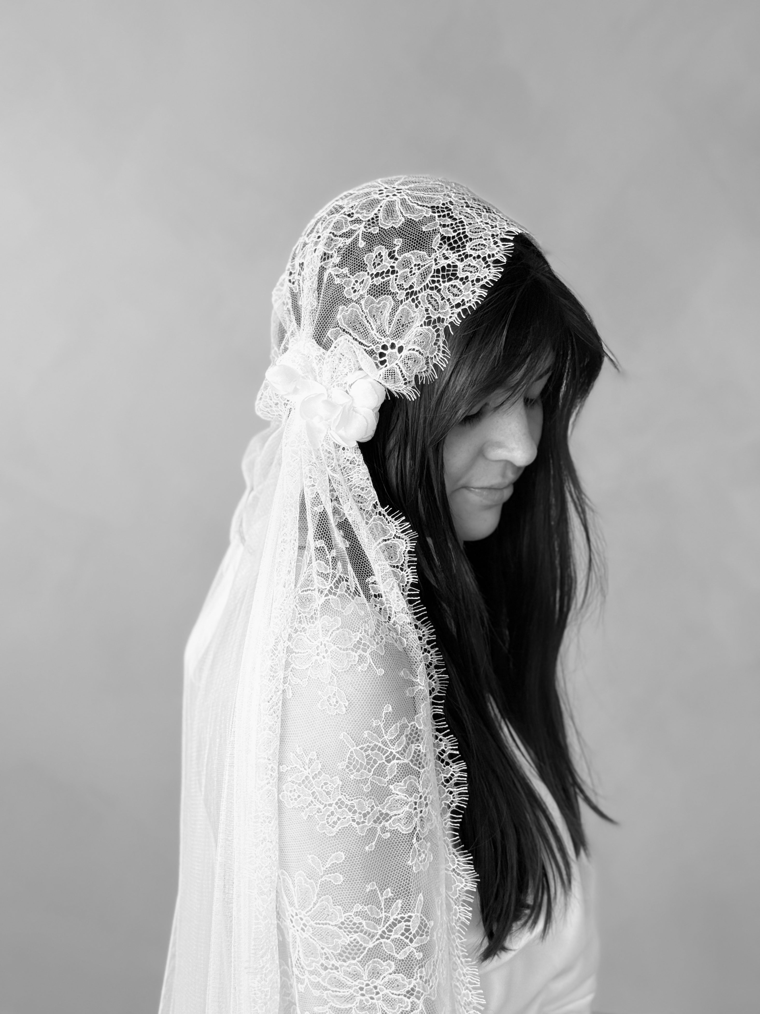 Bride wearing Amélie Juliette cap veil with silk roses and French lace, side profile