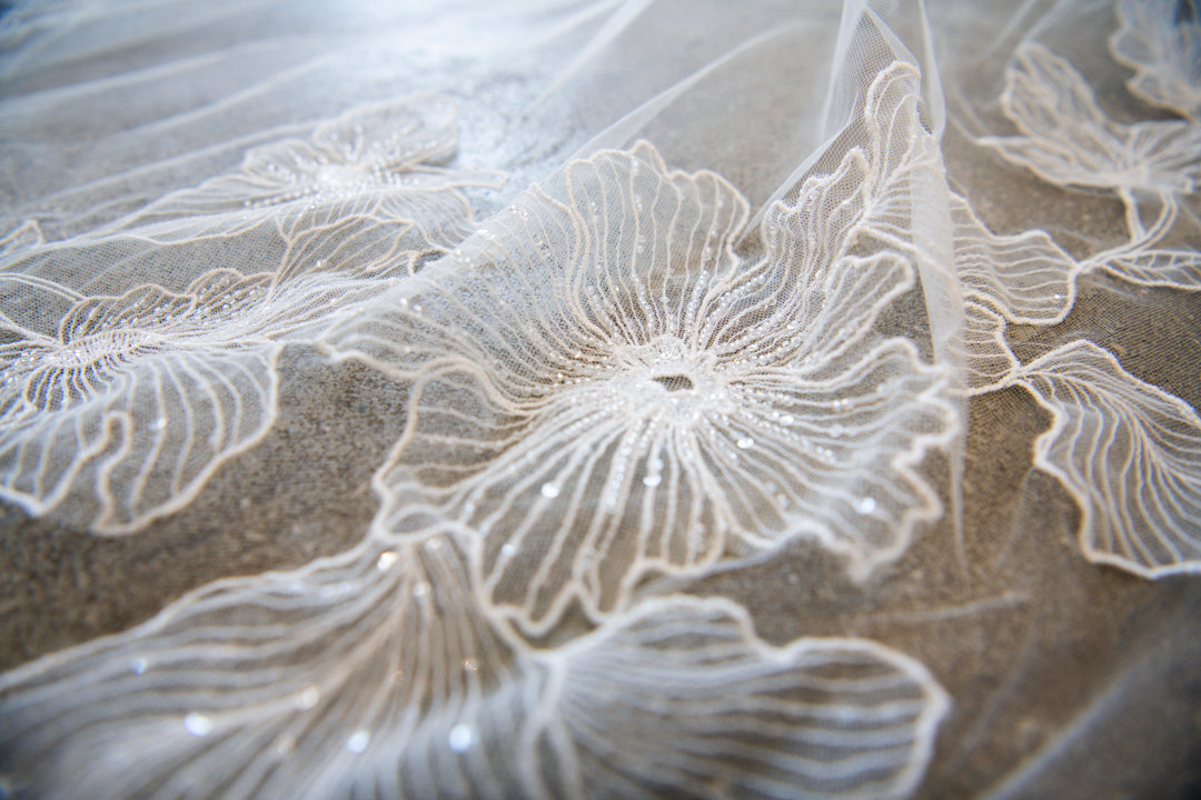 Close-up of hand-placed beading and French floral embroidery on Chant d'Étoiles veil