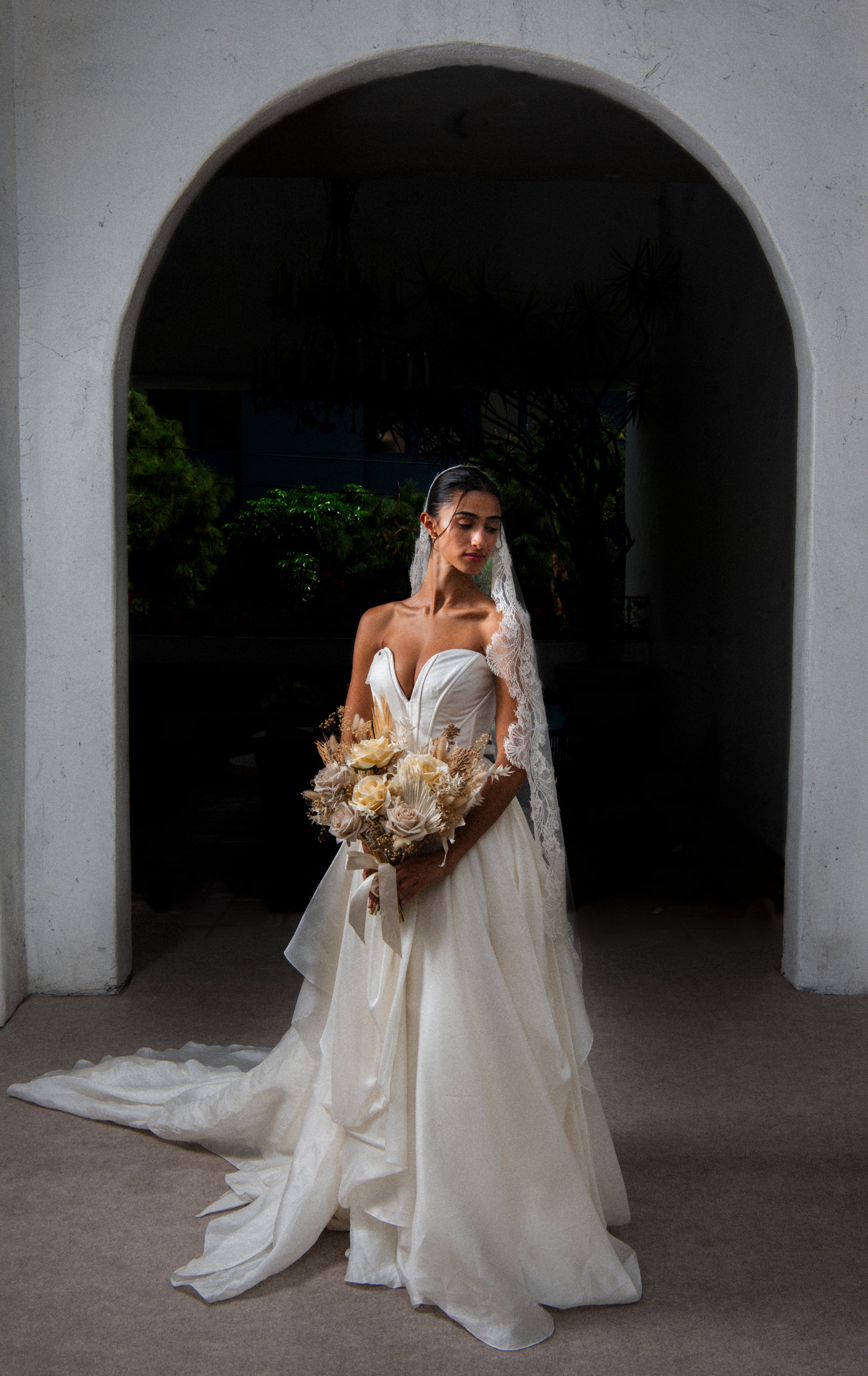 Clair de Lune cathedral mantilla veil in warm ivory tone, side profile bride shot paired with Carol Hannah Senara satin faced organza wedding dress