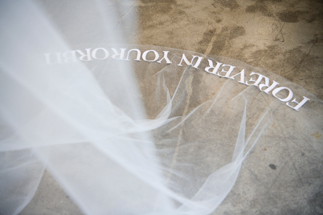 Close-up of Forever in Your Orbit embroidered text on Orion veil