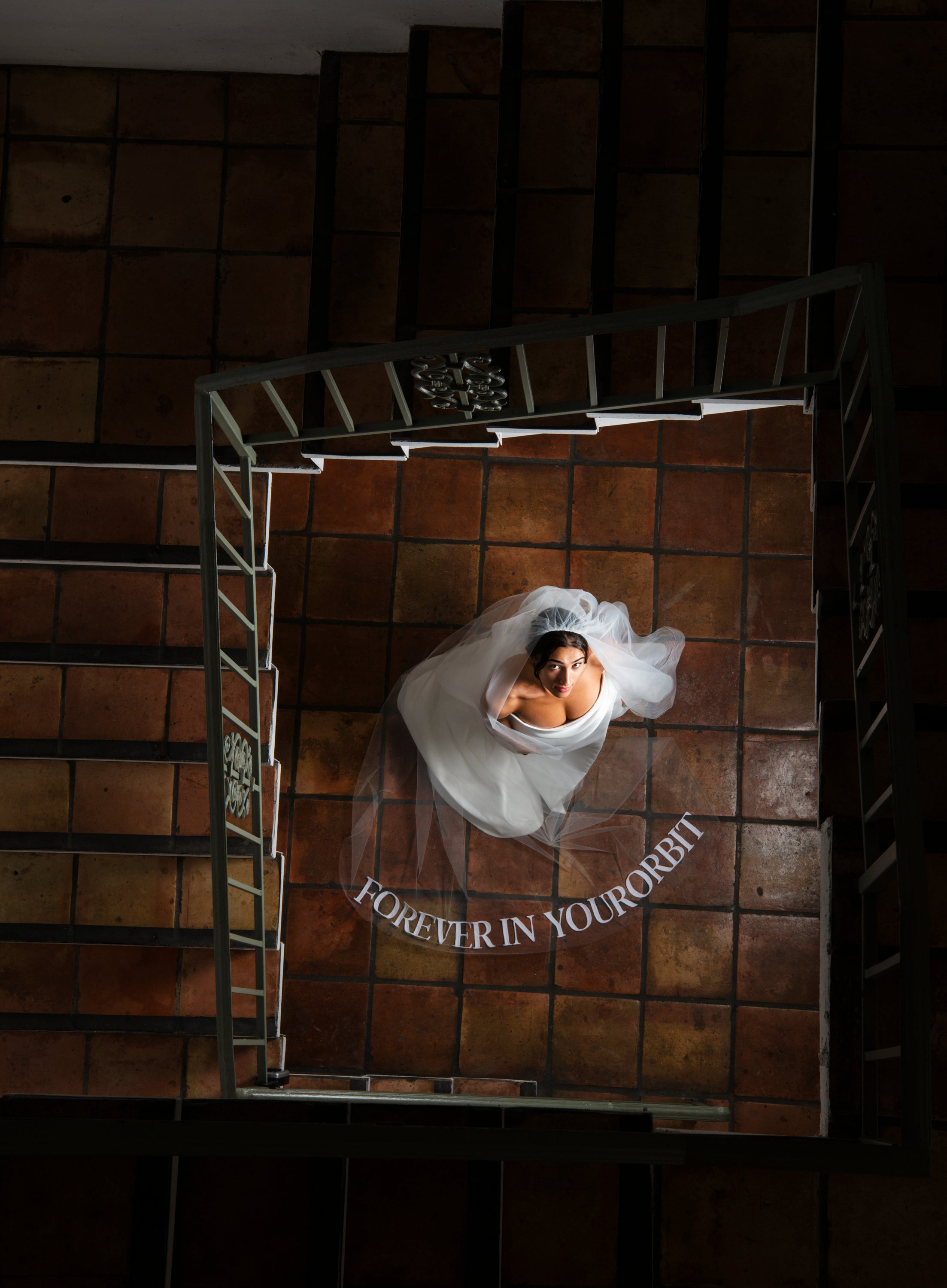 Orion embroidered text veil on Mediterranean tile floor, overhead shot