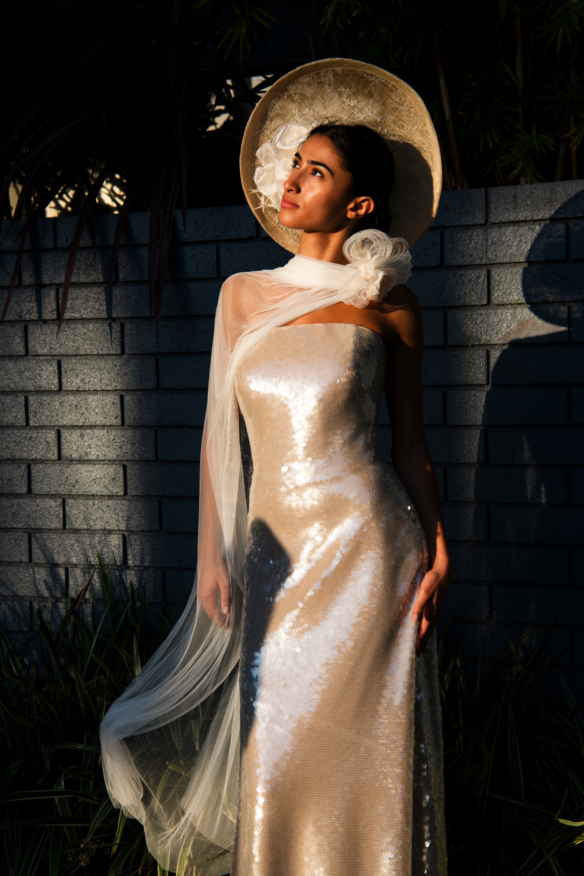 Renoncule couture flower brooch styled with gold reception dress at golden hour